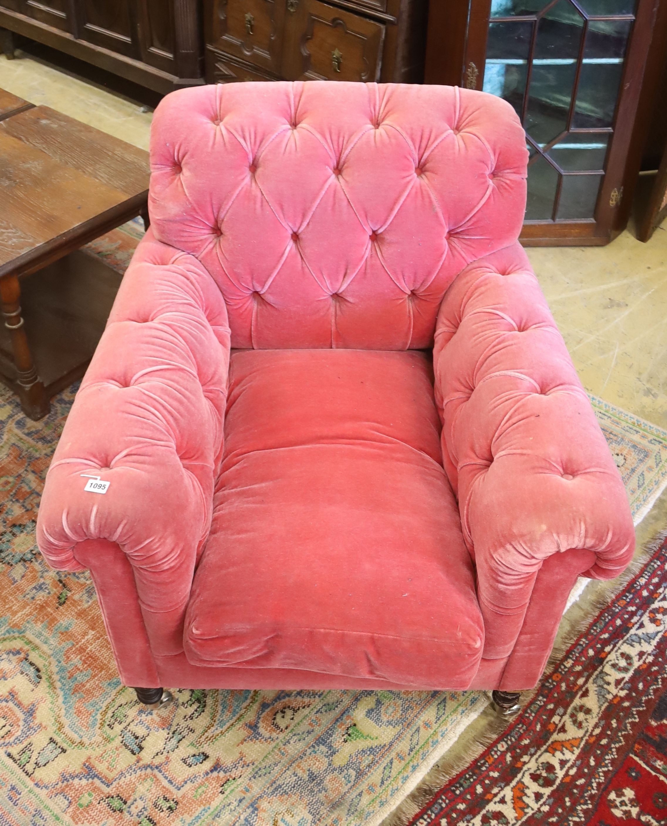 A George Smith armchair upholstered in buttoned pink fabric on turned legs, width 86cm, depth 95cm, height 80cm